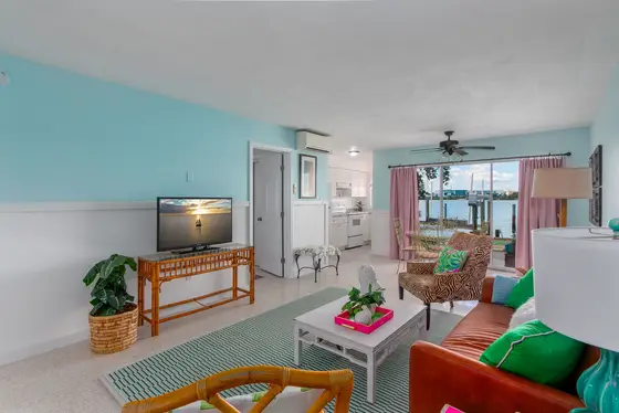 Cozy waterfront living area with a comfortable couch and Smart TV—perfect for relaxing after a beach day.