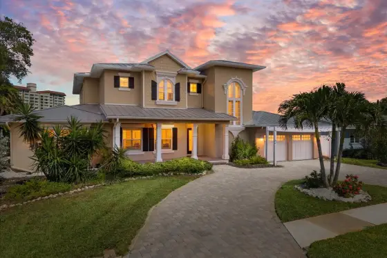 This spacious two-story waterfront home is designed for laid-back coastal living, with comfortable furnishings, multiple gathering spaces, and direct views of the sparkling bay.