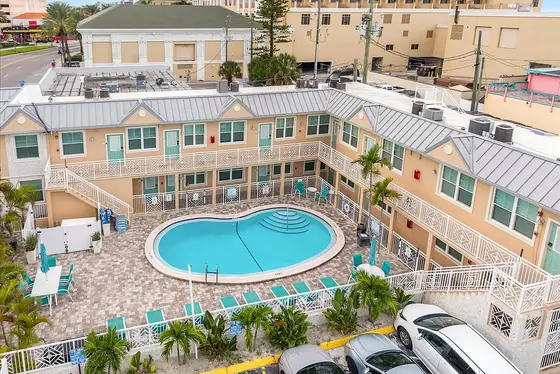 The resort-style courtyard centers around the swimming pool, with lounge chairs and outdoor seating available around the deck.