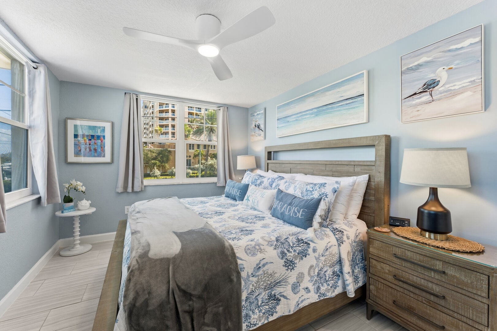 Clearwater Beach Suites 201: Primary Bedroom: A serene sanctuary featuring a King-sized bed, ample storage, smart TV and a ceiling fan.