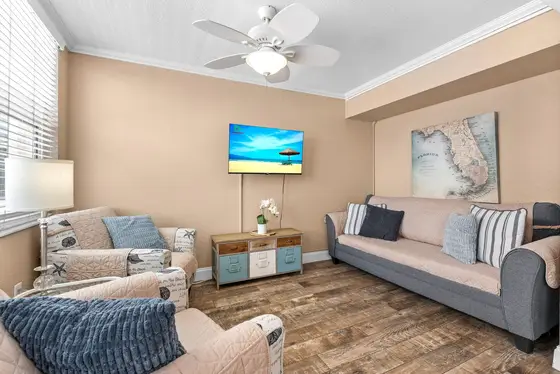 Cozy Living Area with a smart TV, 2 single sofa chairs,  plus a double sofa sleeper for extra guests.