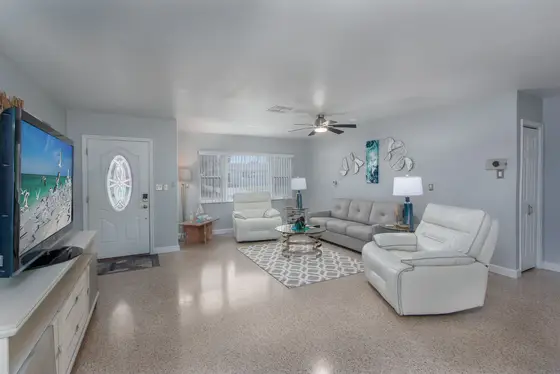 The welcoming living room offers a queen sleeper sofa, creating extra space for guests to relax, gather, or settle in for a comfortable night's sleep.