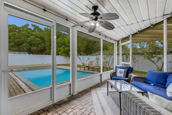 Screened Florida Room – The ultimate hangout spot with comfortable outdoor furniture and a TV to catch the game.