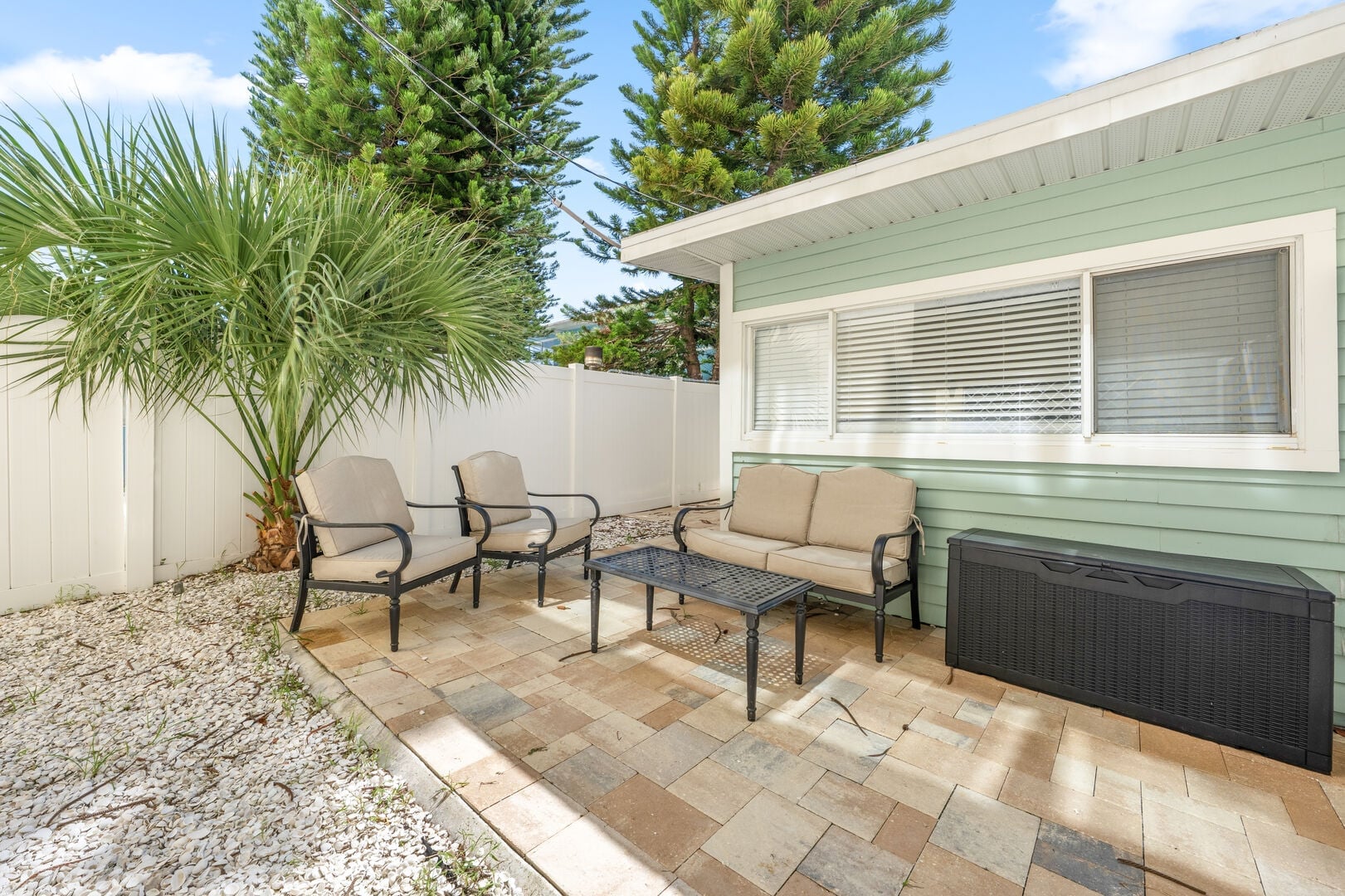 Sandy Shores 1: Soak up the Florida sunshine on your private-feeling patio, with cushioned outdoor seating surrounded by tropical landscaping.