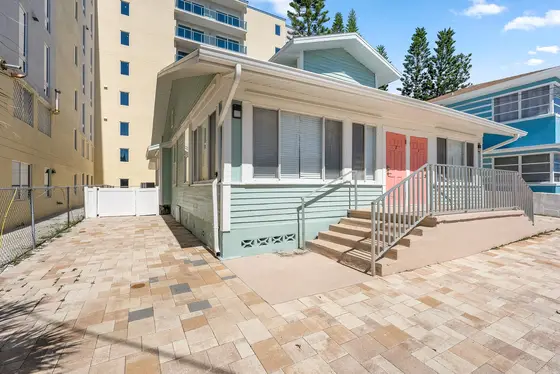 Enjoy the relaxed beach-house atmosphere of 20 Kendall 2, with its pastel exterior, spacious paved entry area, and convenient front steps.