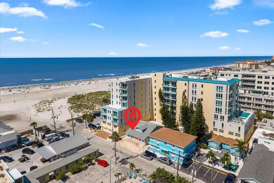 Get a feel for the neighborhood from above, with the vacation home highlighted among colorful coastal buildings and swaying palms.