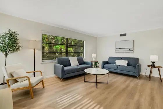 Lounge in the spacious living room that features 2 huge couches, a smart tv, and a lot of natural light.