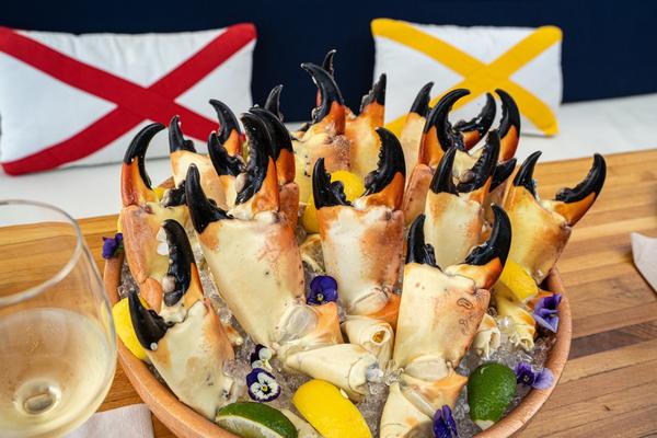 many florida stone crabs on ice on a serving platter