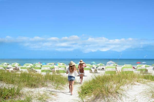 girls walking on the beach on summer vacation