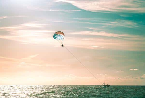 people parasailing at sunset in clearwater beach florida
