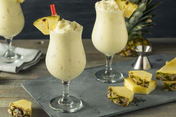 homemade frozen pina colada cocktail with a pineapple garnish