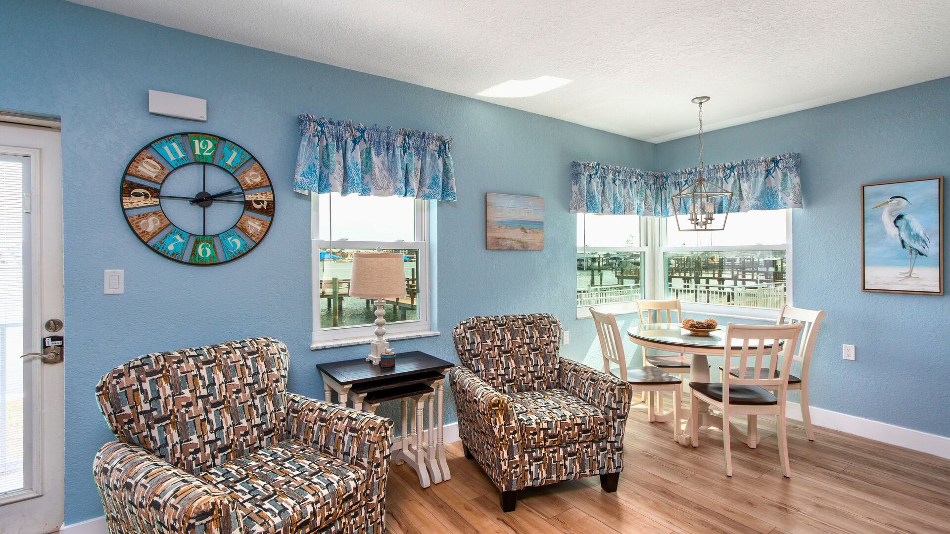 Large windows fill the space with natural light and frame the majestic water views.