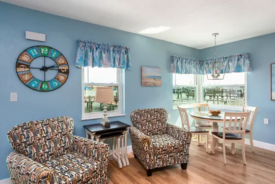 Large windows fill the space with natural light and frame the majestic water views.
