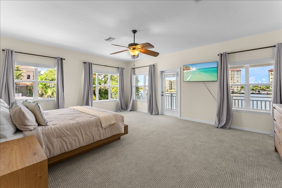 The spacious primary bedroom offers a king bed, dedicated workspace, walk-in closet, and beautiful bay views.