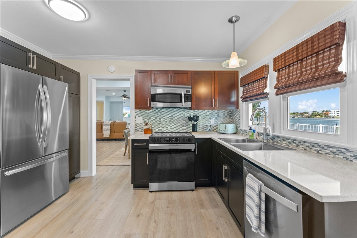 Prepare your favorite meals while enjoying peaceful waterfront views from the heart of the home in this thoughtfully designed kitchen space.