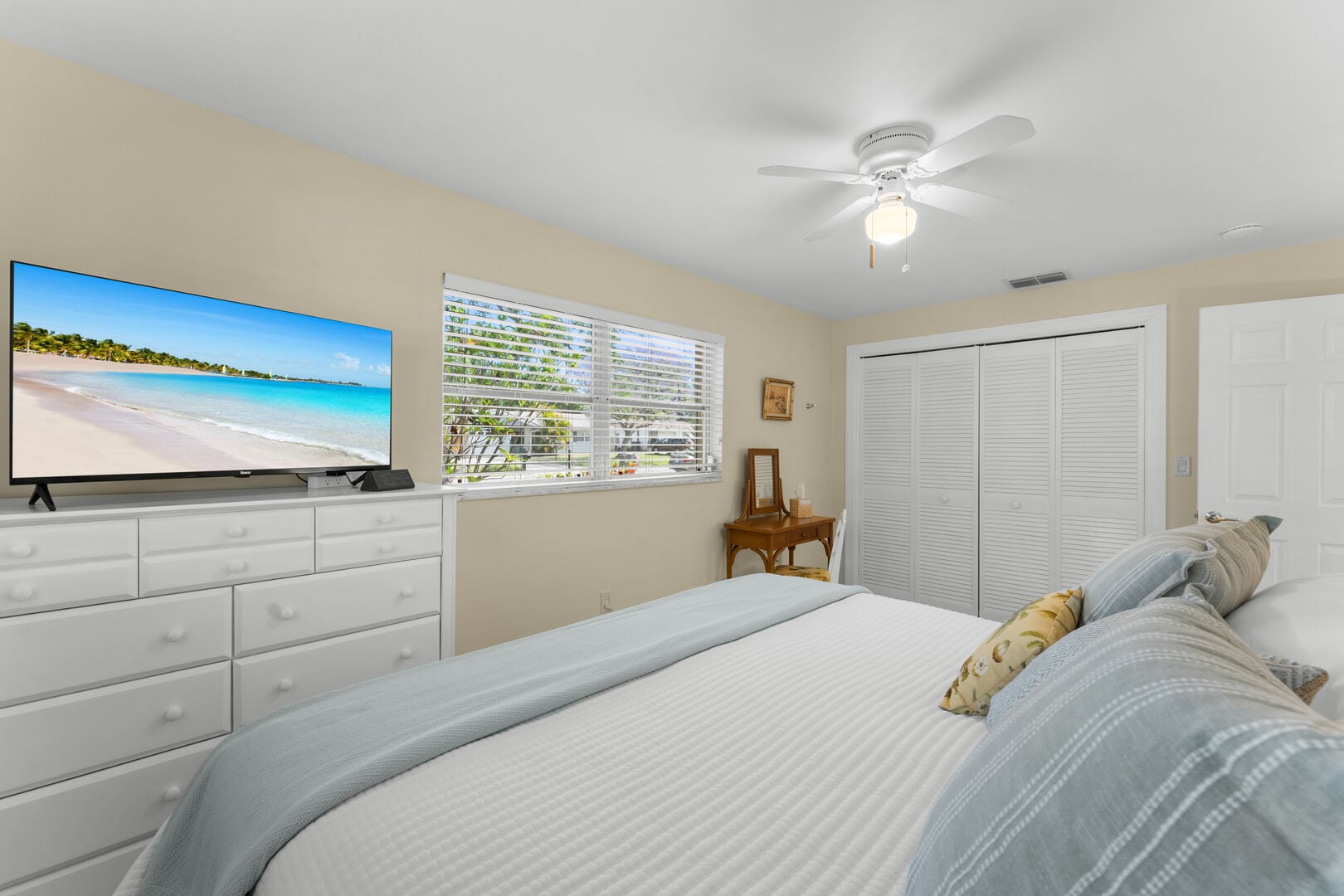 Spacious bedroom with a comfortable bed and smart TV