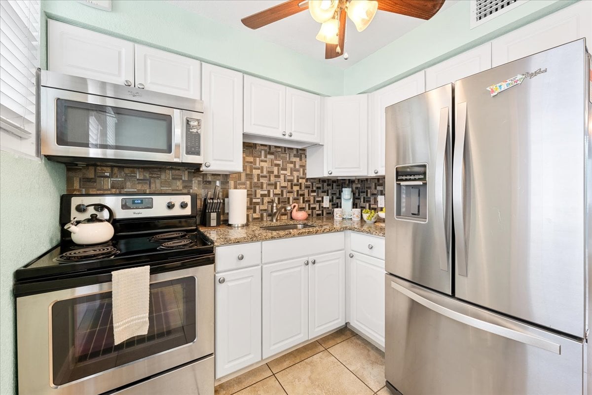 Prepare everything from morning coffee to a home-cooked dinner in the stocked kitchen with full-size appliances, granite countertops, and plenty of cabinet space.