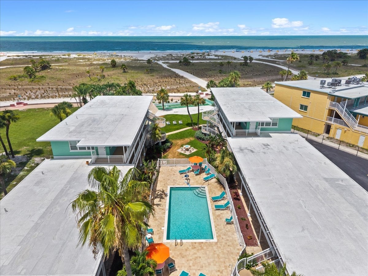 Tropic Terrace sits right on the beach, with a lush pool courtyard tucked between buildings and the Gulf just steps away. Sun, sand, and resort charm all in one place.
