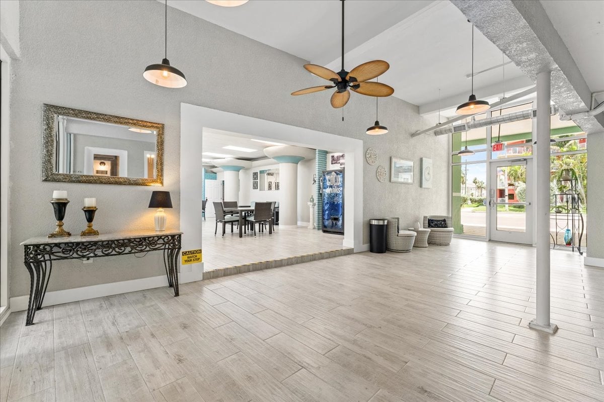 Bright, airy lobby and guest lounge with soaring ceilings and coastal décor — a welcoming introduction to your Tropic Terrace getaway.